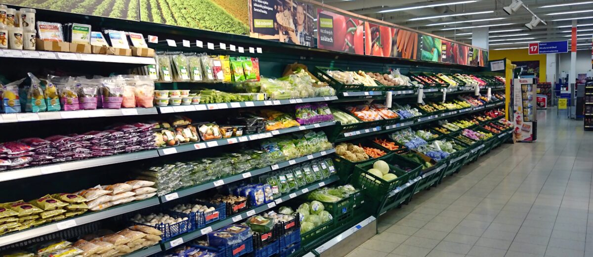 Refrigerator full of the vegetables at grocery store.